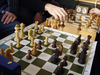 Bughouse chess (or doubles chess or Siamese chess). 